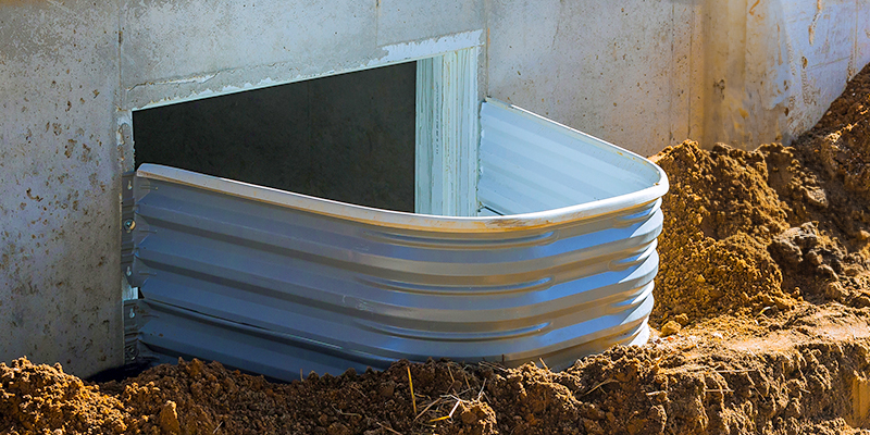 An egress window is coming out of a basement.