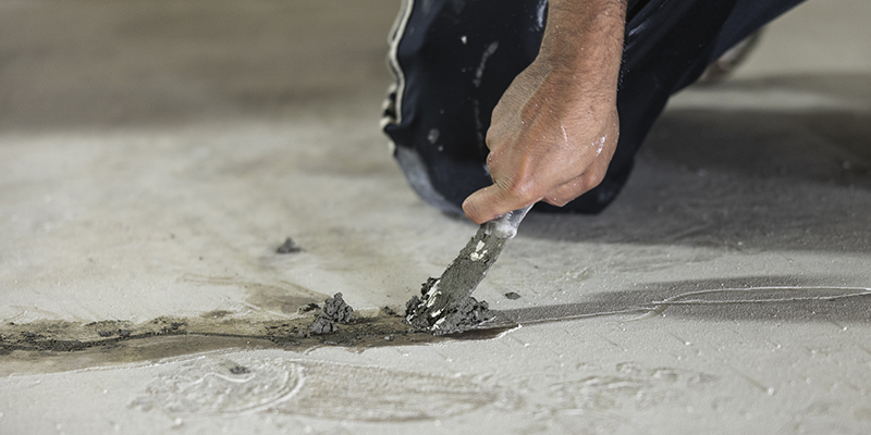 Hydraulic cement used for sealing cracks in the floor to waterproof the basement.