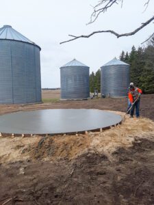 A concrete slab is being prepped for a silo.