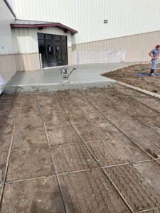 A foundation to continue laying a sidewalk outside of a business.