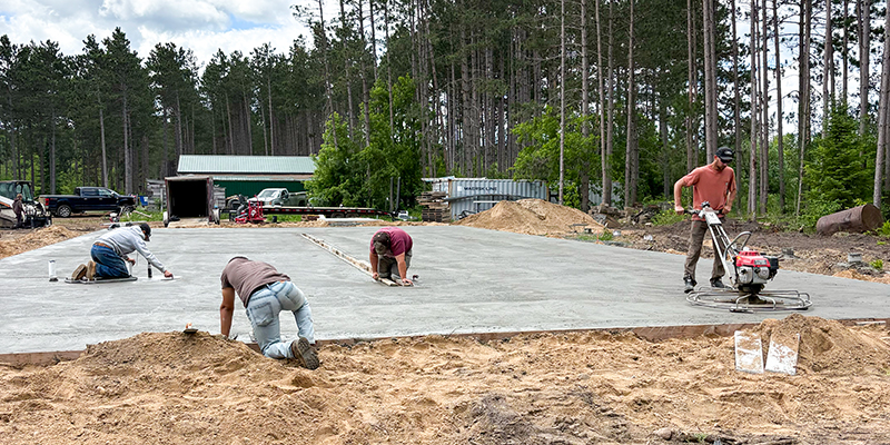 Concrete-Foundations-Feature-2 Concrete crew finishing a large residential concrete slab foundation by Trepanier Masonry in Bemidji, MN.