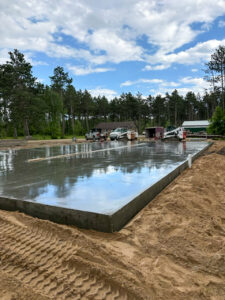Freshly poured residential concrete slab foundation completed by Trepanier Masonry in Bemidji, MN.