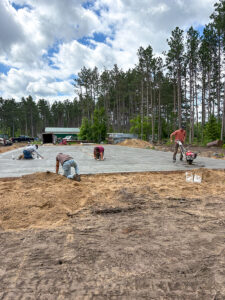 Concrete crew finishing a large residential concrete slab by Trepanier Masonry in Bemidji, MN.