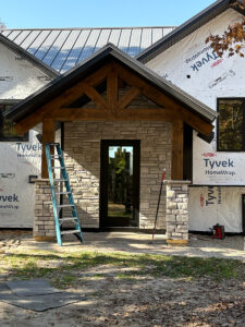 Custom stone veneer front entry and masonry columns under construction by Trepanier Masonry in Bemidji, MN.